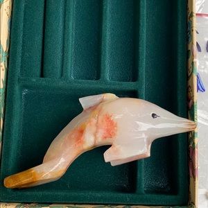 Hand carved stone dolphin with black eyes